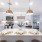Gold pendant lights over a white kitchen island