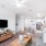 Open concept apartment with white walls and cozy furniture