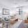 Living room with bright window and white walls