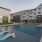 Resort style pool with aqua lounge chairs