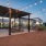 Picnic tables under a pergola with string lights