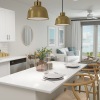 Spacious and well lit kitchen with wood floors and stainless steel appliances